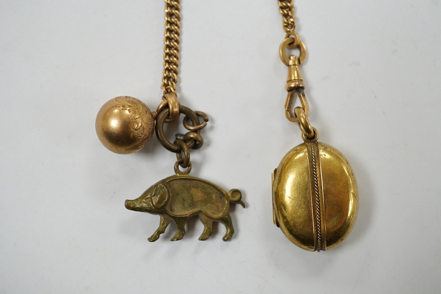 A Victorian yellow metal oval locket, with rope twist band, overall 29mm and a yellow metal fob chain. Condition - fair